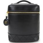 Trousses de toilette de créateur Chanel noires en cuir seconde main look vintage pour femme 