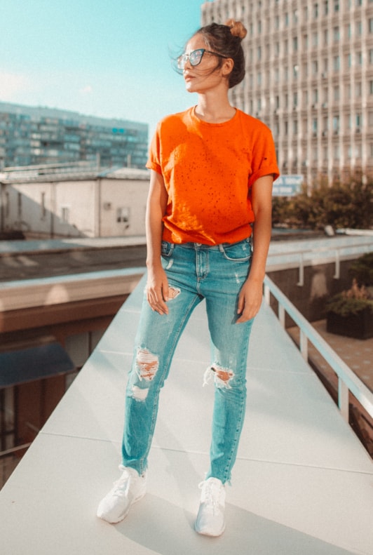 sneakers, orange shirt, denim jeans